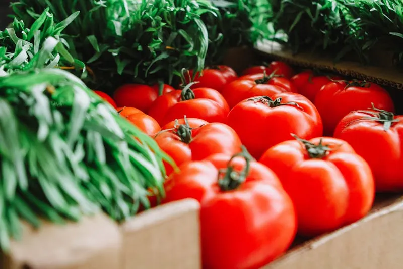 Fresh tomatoes and greens at a farmers market